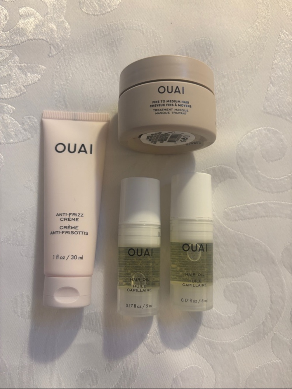 OUAI hair oil, anti-frizz crème, and hair masque